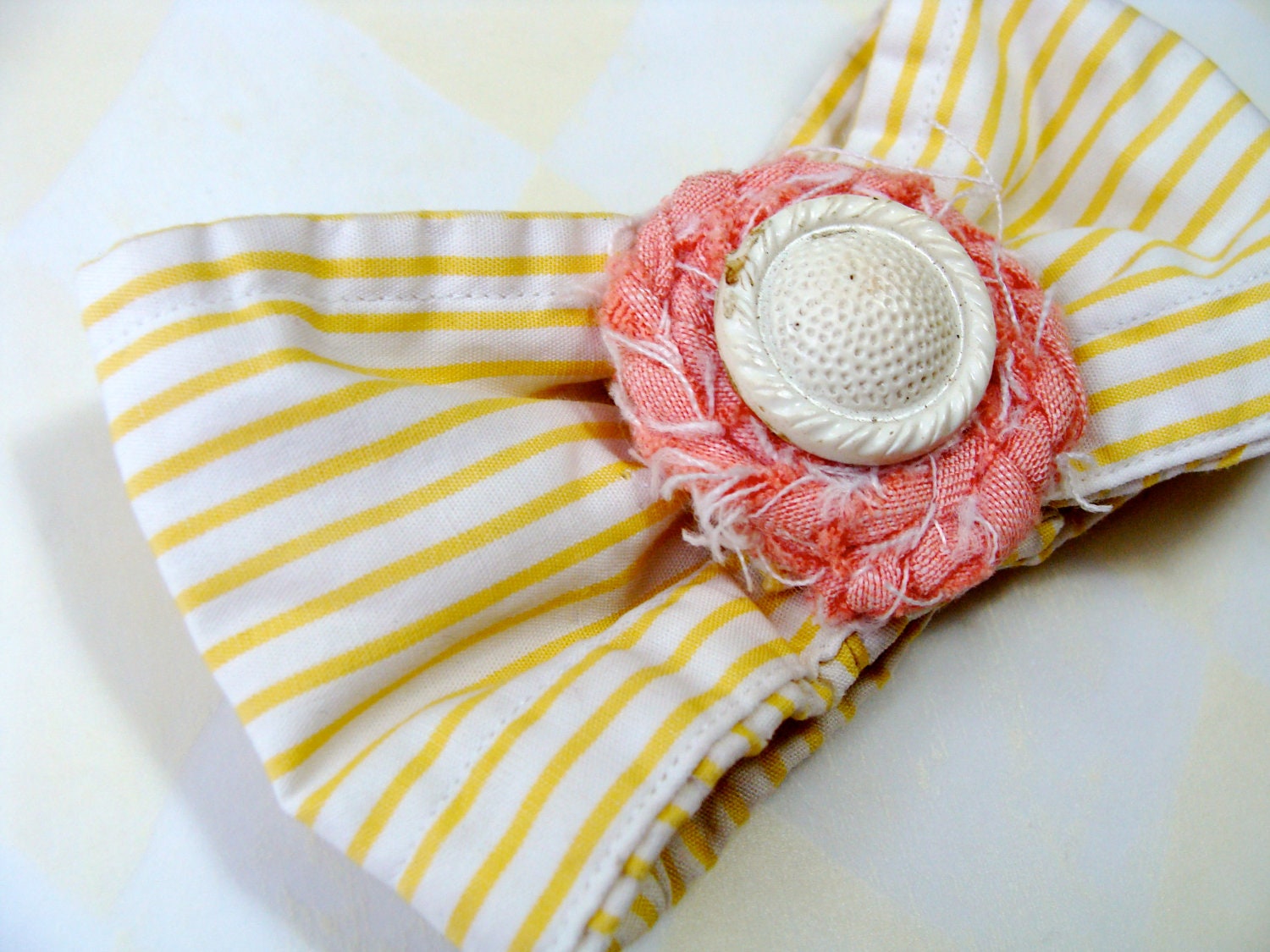 upcycled hair bow from ChatterBlossom on Etsy with stripes of yellow, pink braided center and vintage white button