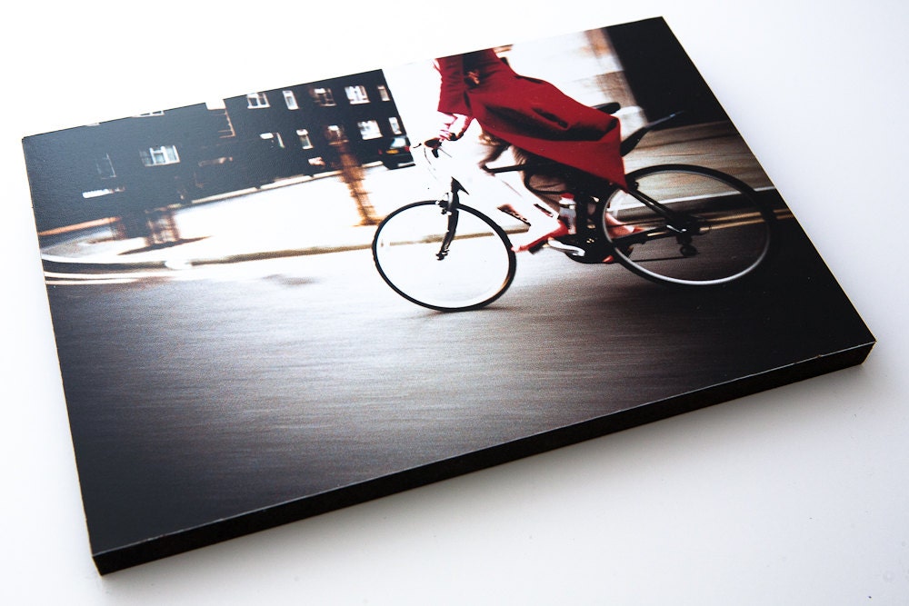 Girl on in red coat riding her bicycle.  9" by 6" Wooden block mounted Lomo Photograph. Shot on Film.