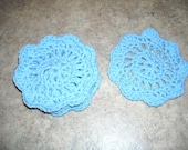 a set of 4 coasters made with cotton yarn.  Color is more of a dusty blue