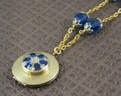 Core of the Machine locket necklace in vintage brass with cobalt blue glass
