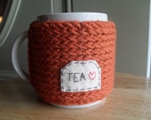 knitted mug cozy cup cozy in burnt pumpkin orange with felt tea patch