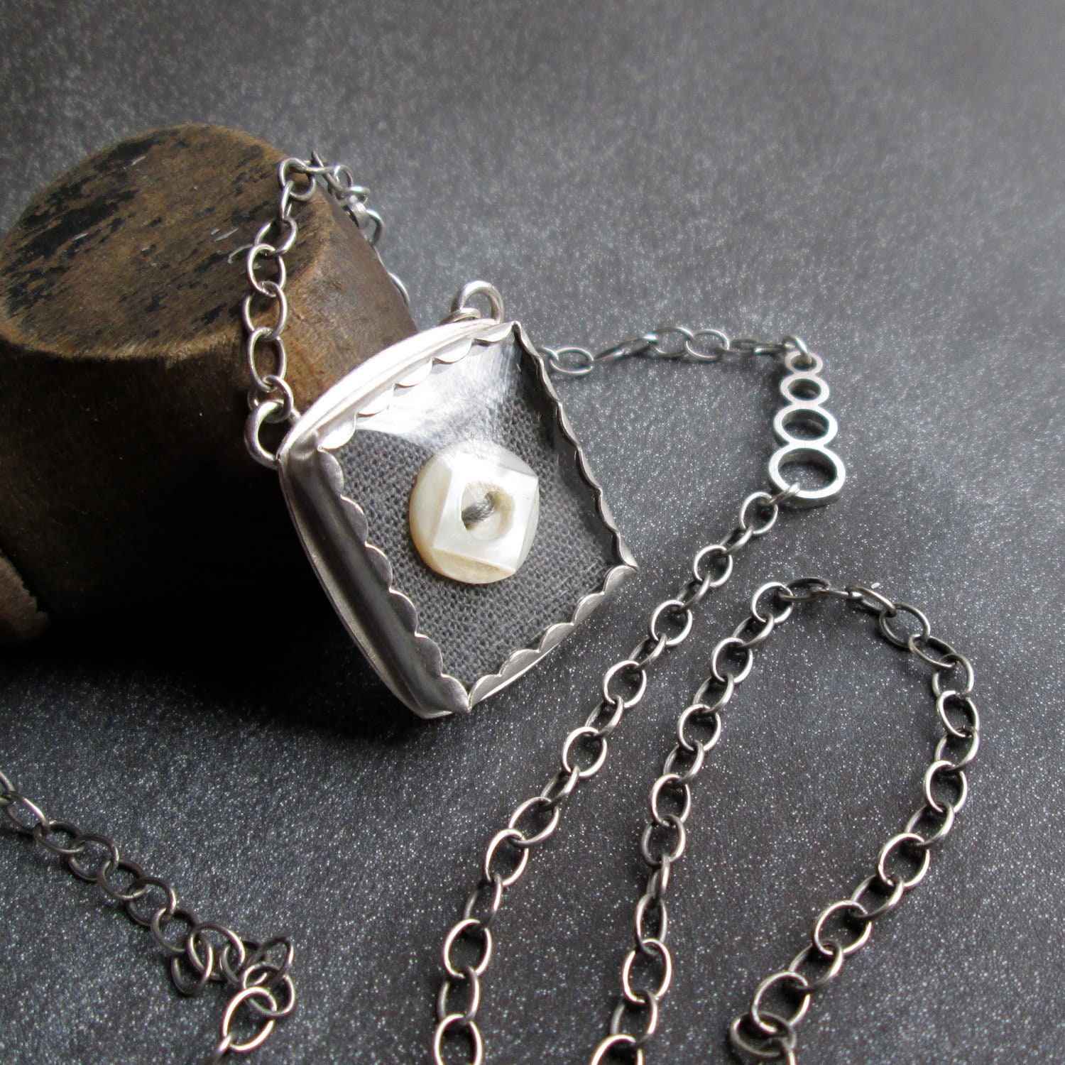 PENDANT sterling silver, square watch crystal, gray linen, and old button
