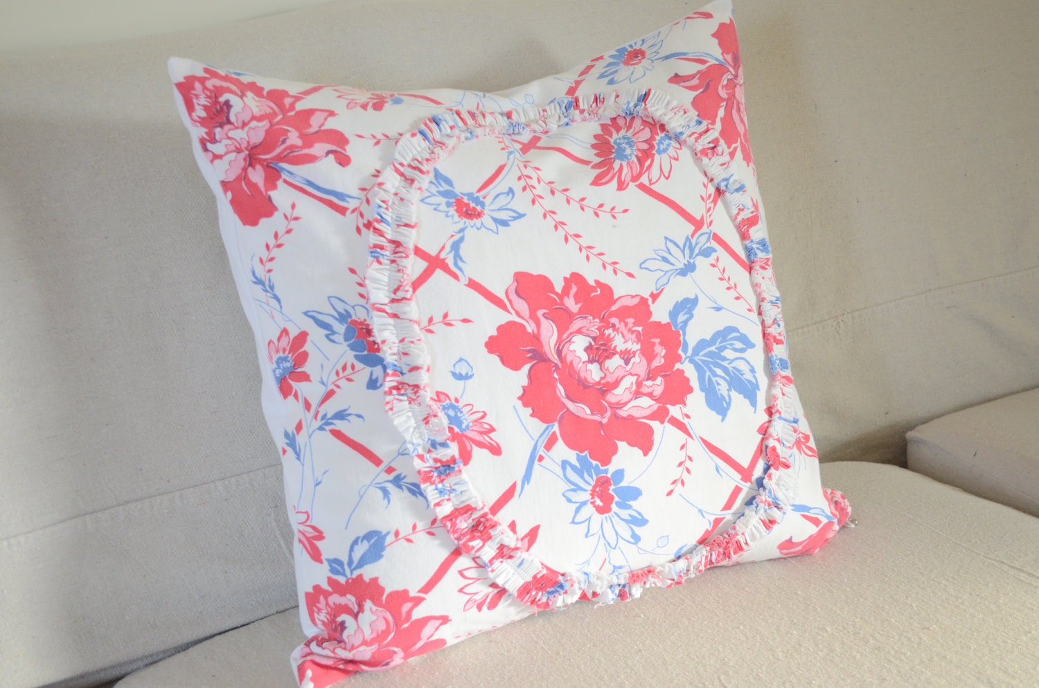 Pillow made from a vintage tablecloth red and blue flowers on white