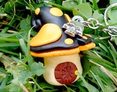 Toxic mushroom keychain in black and orange (Halloween combination). Mini gnome apartament with skull charm