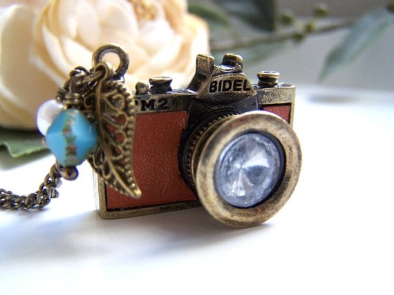 the tan leather camera necklace.