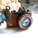 the tan leather camera necklace.