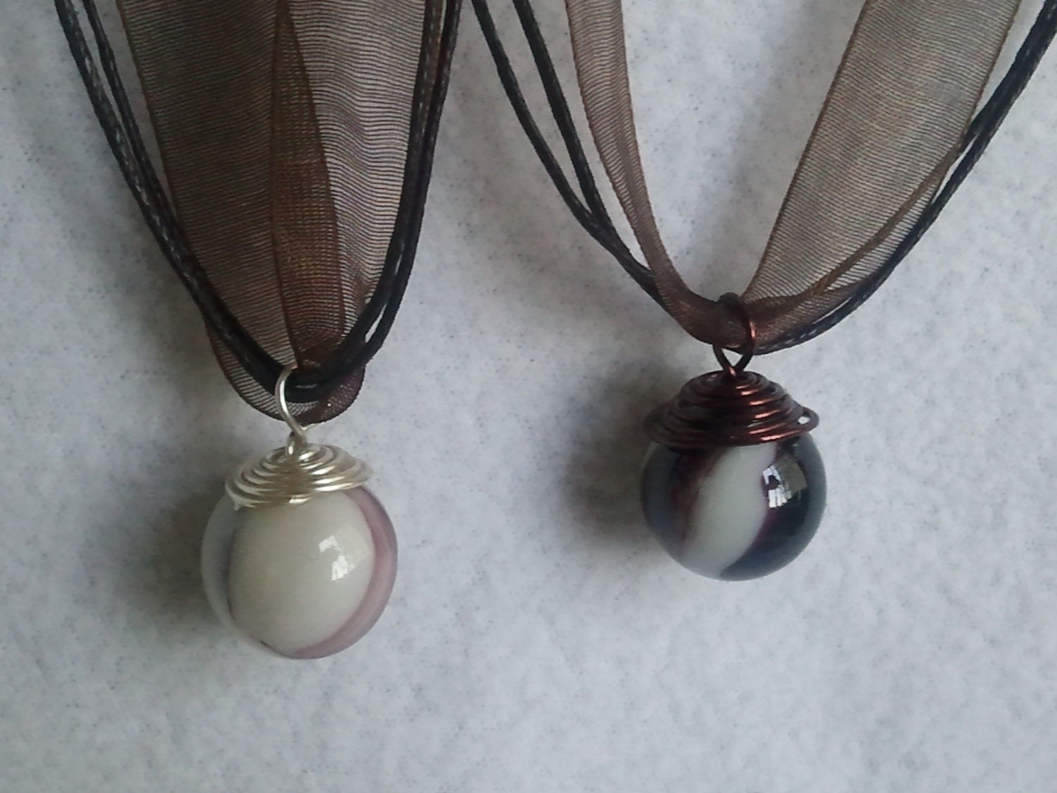 White with brown swirl   Marble on  a dark brown  ribbon necklace