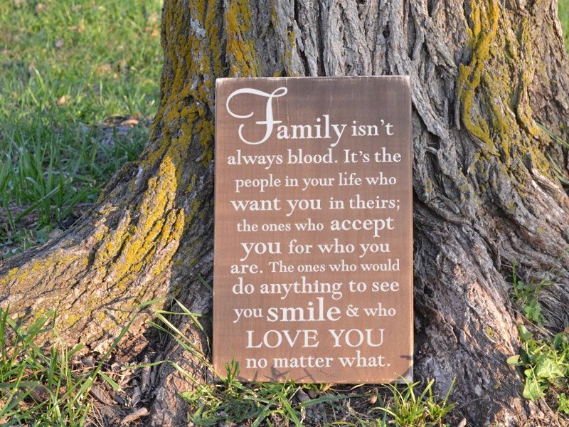 Family isn't always blood painted wood sign