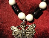Float Like a Butterfly: Handmade Child's Necklace Featuring Purple and White Glass Beads and a Butterfly Charm-- Sale Price