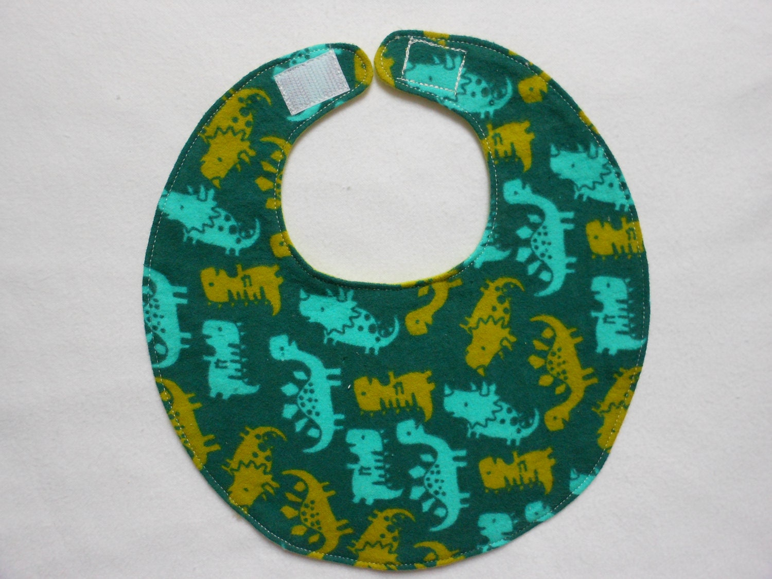 Baby Bibs, four soft layers, reversible, dark teal with green and blue baby dinos