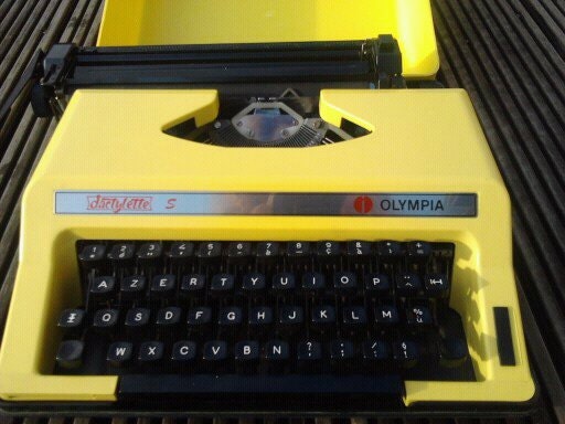 Vintage yellow typewritter Olympia working