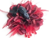 Red and black flower fascinator with encrusted real animal skull.