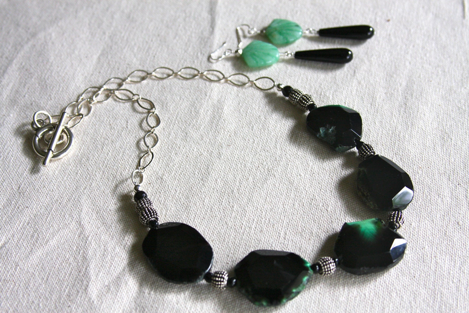 Necklace made with Black agate with a splash of green,onyx stones, pewter beads and sterling silver chain
