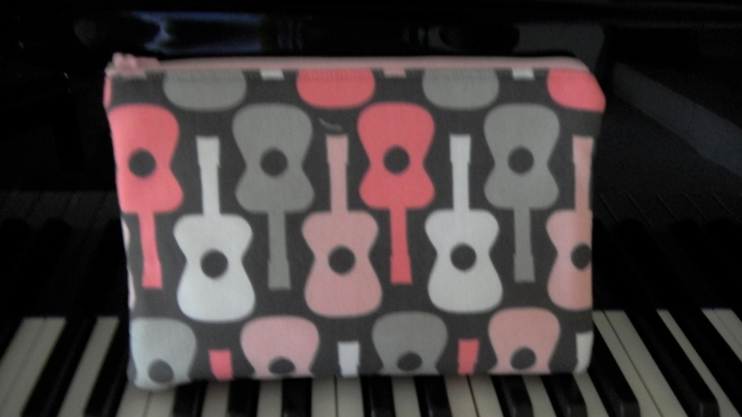Musician's zippered pouch featuring guitars in pink, gray and white