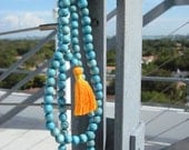 Handmade necklace Mala with 108 blue wood beads and orange pompom