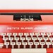 Vintage red typewriter by Byron Jardine Limited