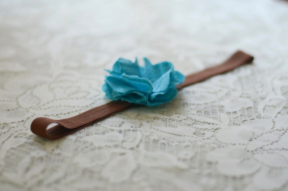 blue fabric flower on chocolate brown headband