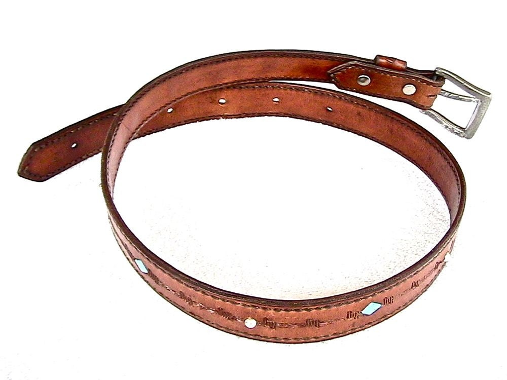 Leather belt with turquoise and silver bead inlay and barbed wire motif.