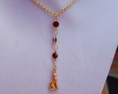 Cat necklace features 24k double plated gold pendant accented with 3 6mm red or siam swarovski crystal links on a gold colored chain