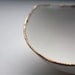 Stoneware fine bone china bowl with 10% real gold resembles a small boat.