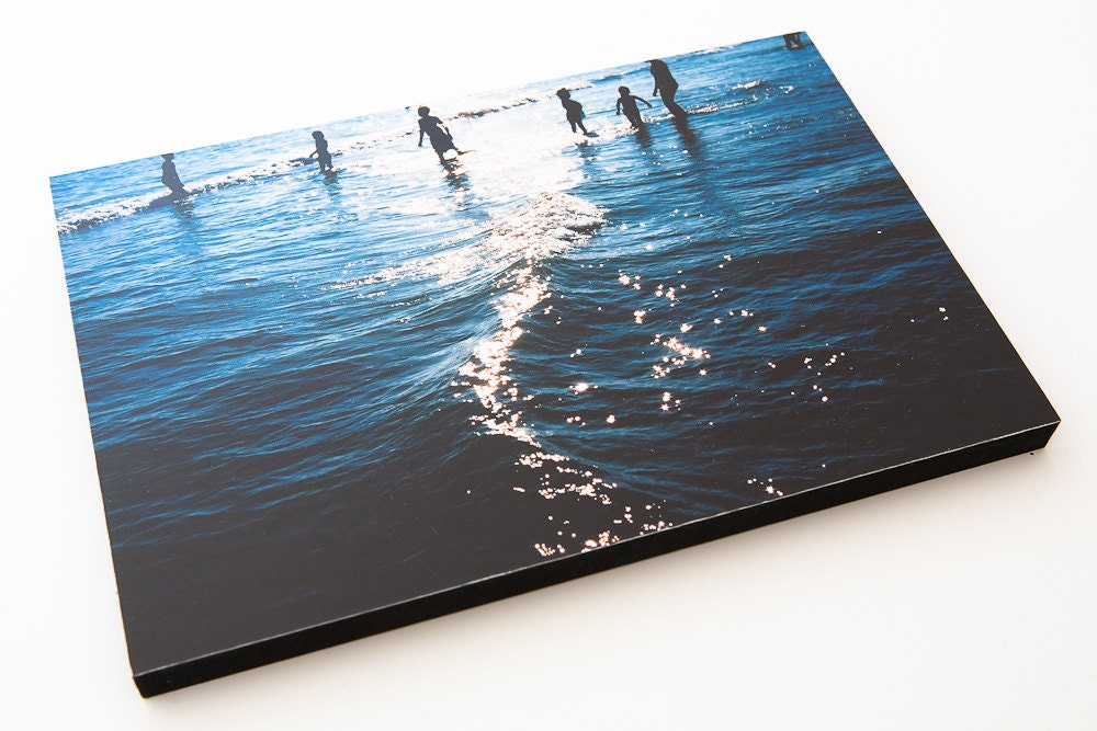 Children playing in the sea in summer time.  9" by 6" Wooden block mounted Lomo Photograph. Shot on Film.