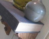 floating shelf made with a vintage book. literally a book shelf. :)