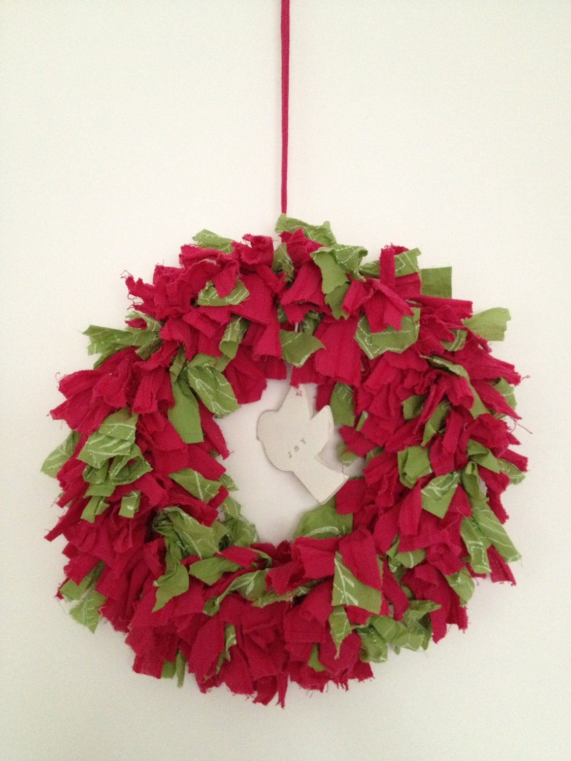 fuschia pink and green rag wreath, with a hanging wooden dove. - NancyLoves