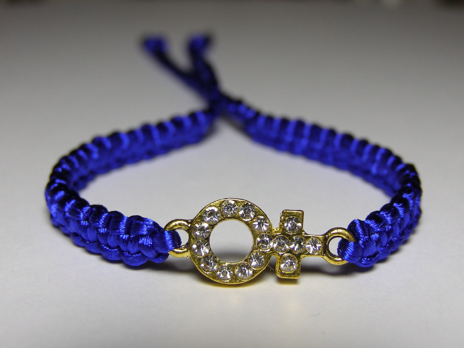 Venus symbol bracelet in golden metal with rhinestones