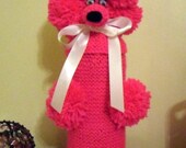 Charlie the bright pink Gin Poodle with a white ribbon bow collar
