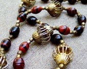 Brass Lanterns - Marble Red Black Glass Bead Strand Necklace with Gold Bird Cage Findings and Metal Spacers