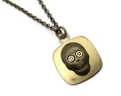 Steampunk Necklace Skull with geared eyes in gold brass by Dr Brassy Steampunk