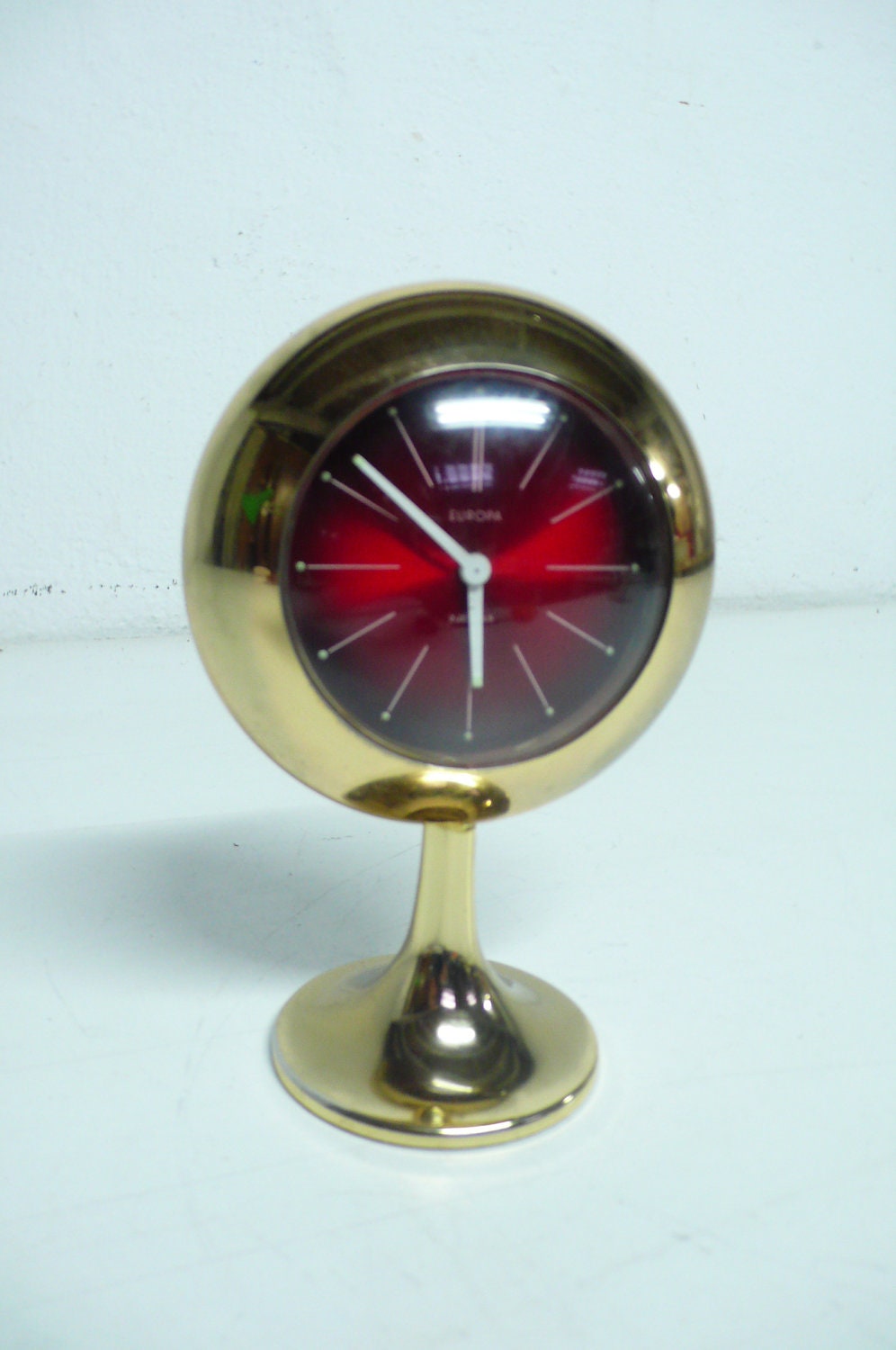 Vintage retro space age  alarm clock in gold and red colors