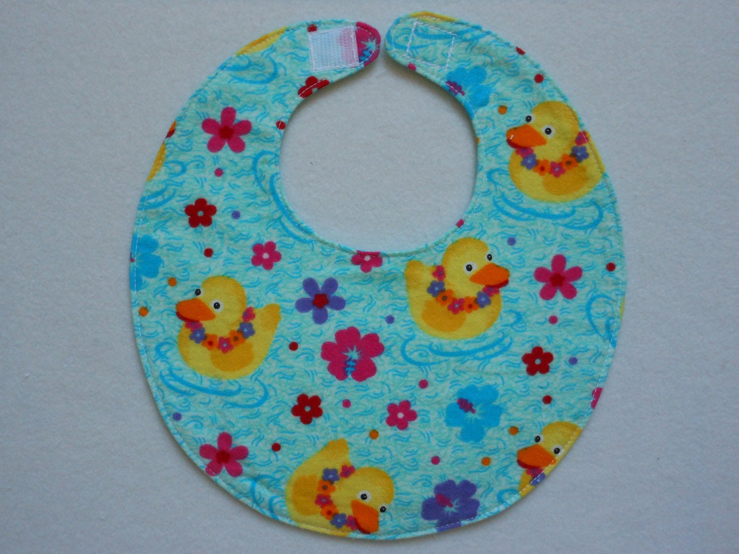 Baby bib, four soft layers, reversible, blue with aloha ducks