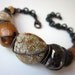 Exit Everything - primitive tribal industrial ceramic beads, tribal seeds, conch shell, pearl, stone nuggets, & chunky black brass bracelet