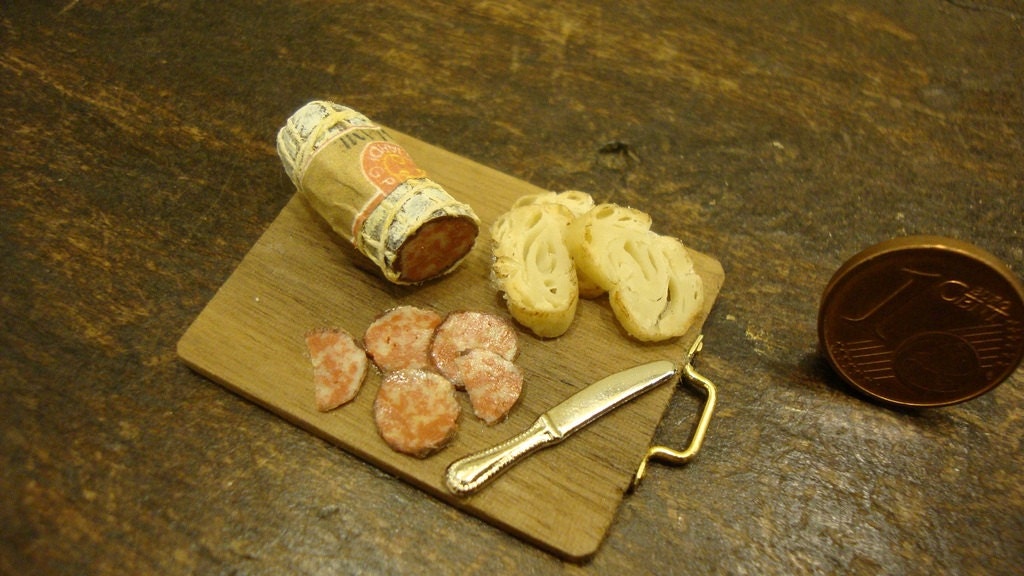 miniature chopping wood with salami and bread