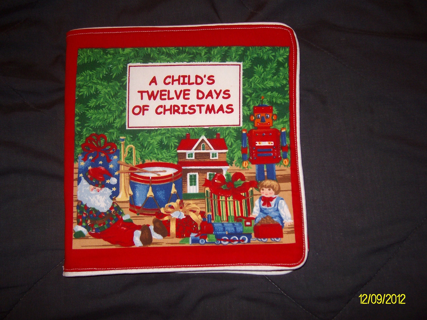 A Childs 12 Days of  Christmas Soft Cloth  Book                   in bright bold colors and piping around the edges