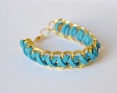Chain & Suede Bracelet.Teal suede wrapped around two gold chains with sienna brown suede in the middle. Small size.