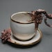Bottom Feeder Tea Cup and Saucer, two