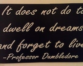 Wall hanging with Professor Dumbledore quote "It does do to dwell on dreams and forget to live"