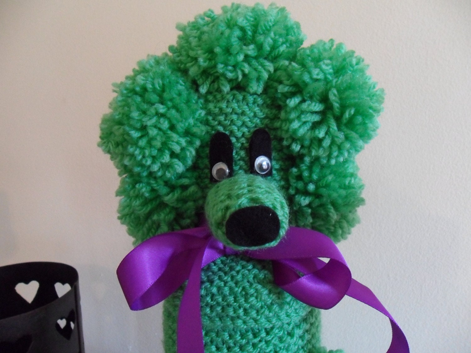 Pea Green Gin Poodle with a purple ribbon bow collar