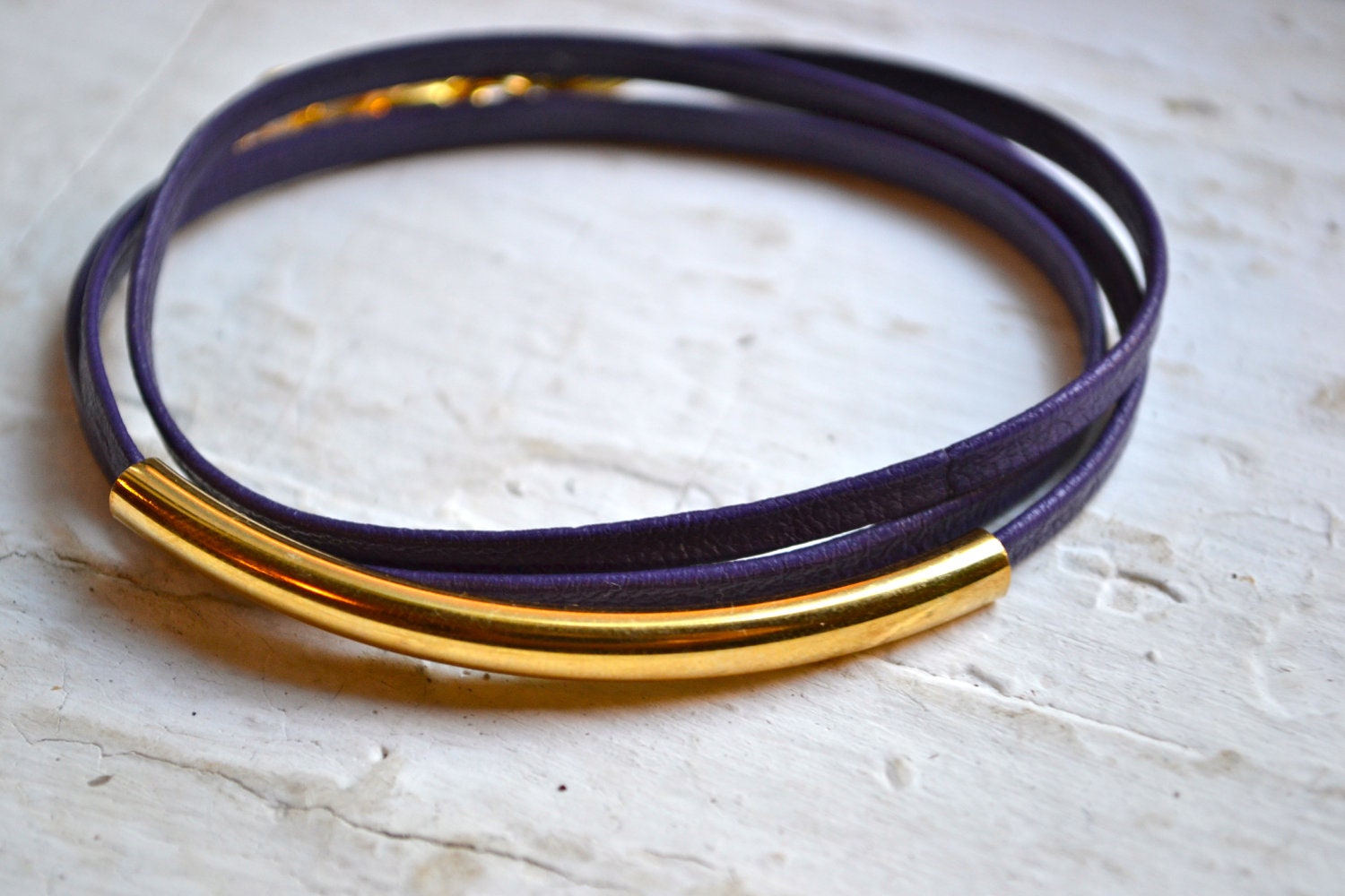 dark purple skinny leather triple wrap bracelet with long gold tube