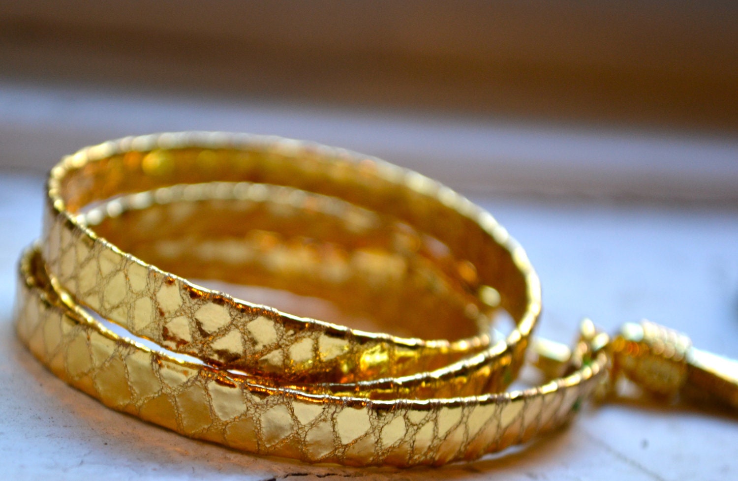 gold on gold metallic snakeskin leather triple wrap bracelet with gold tassel