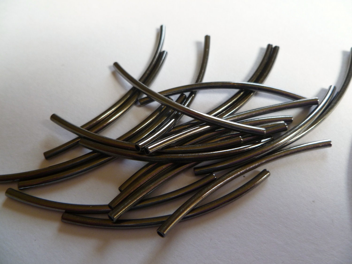 Bead, gunmetal-plated brass, 45x2mm curved tube. Sold per pkg of 20.