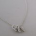 Sterling Silver Knots Necklace. Tiny dangling whimsy knot pendant. Rollo chain -Trio-