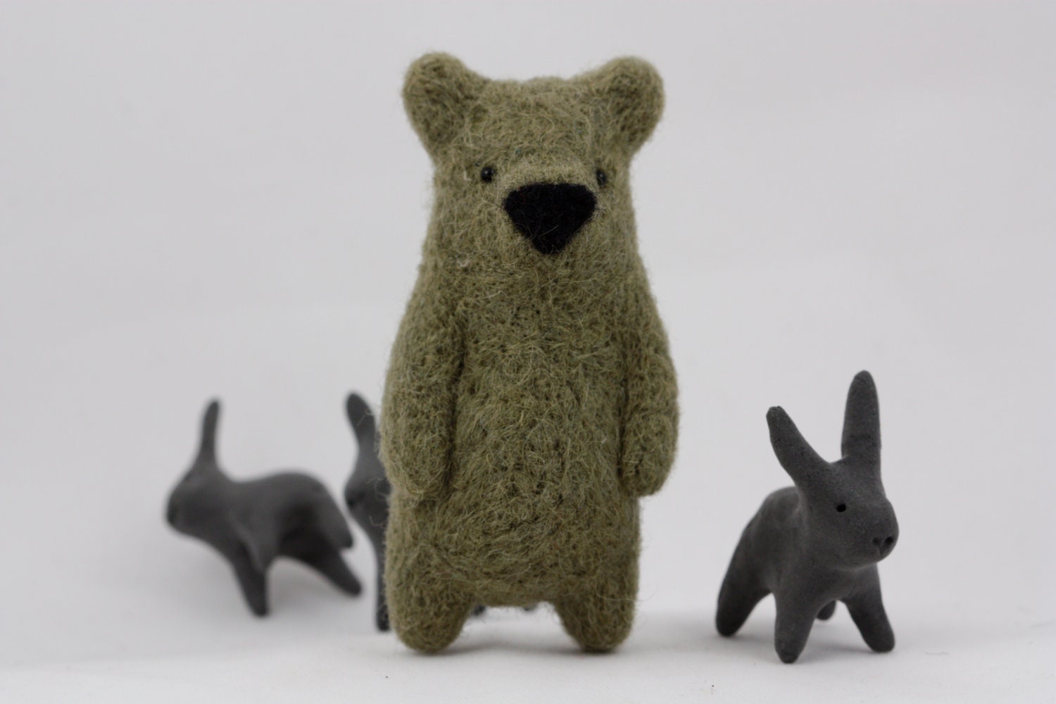 A olive green felted bear brooch