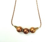 short collar necklace with copper spheres