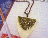 Long gold necklace. Ivory, gold, copper silver, mixed metal jewelry. Tribal design, style. Bone like pendant.