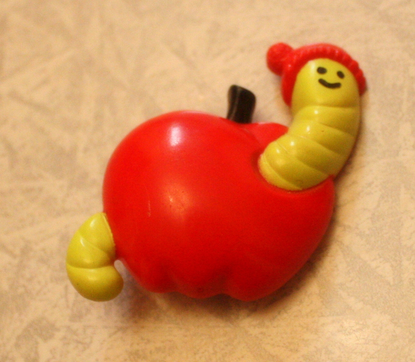 1974 Avon plastic worm in apple pin