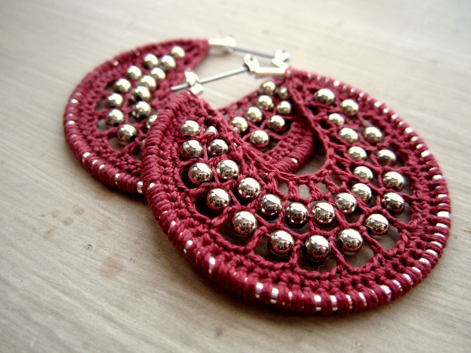 Crocheted hoops with beads in rust pink