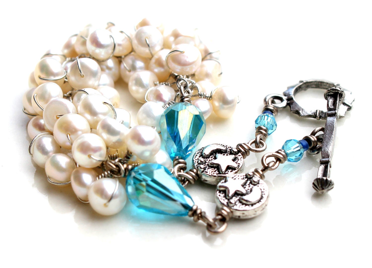 The snow white bracelet. white pearl wrapped bracelet. blue crystal. stars and moon beads